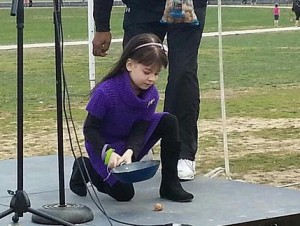 Gabriella smashing a walnut to symbolize smashing out DIPG. The walnut was the same size as the inoperable tumor that took her life  within just one year of diagnosis.